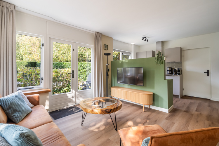 Zithoek met grote ramen en uitzicht op tuin Boszicht 17.